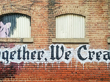 Bild: Steinwand mit Graffiti: Together we create!